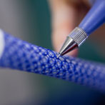 Rhian Malin decorating a mandala bottle in her workshop 2019